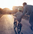 Vader leert kind fietsen